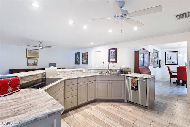 kitchen with light stone countertops, sink, and stainless steel dishwasher