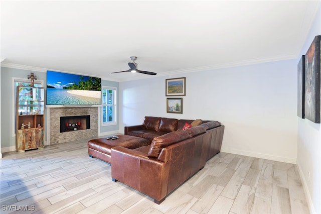 living room featuring crown molding, ceiling fan, and light wood-type flooring