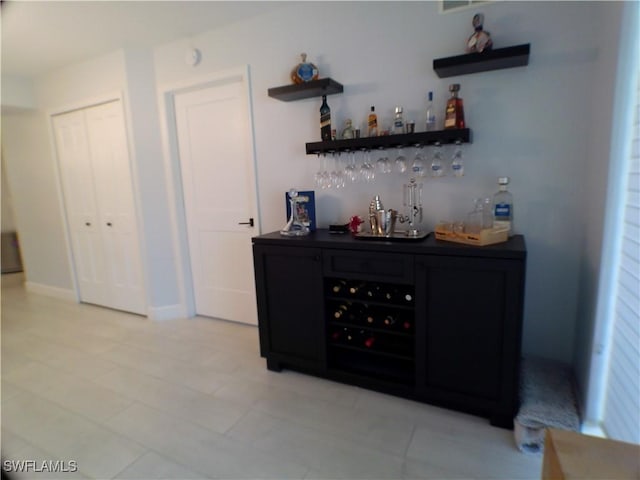 bar featuring light tile patterned floors