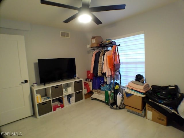 interior space with ceiling fan