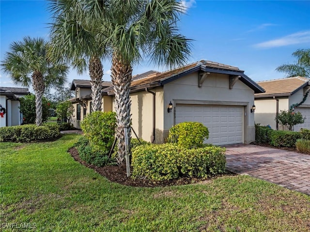 view of front of house with a front yard and a garage