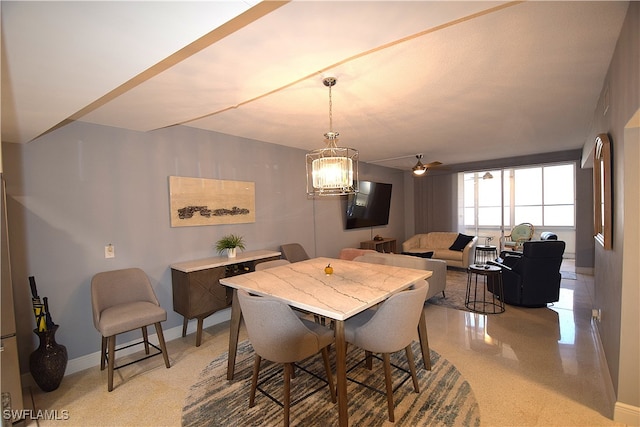 dining space with ceiling fan with notable chandelier