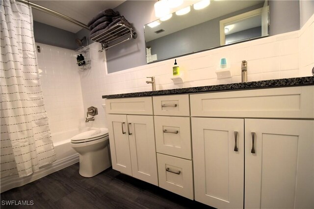 full bathroom with tasteful backsplash, toilet, shower / tub combo with curtain, vanity, and hardwood / wood-style flooring