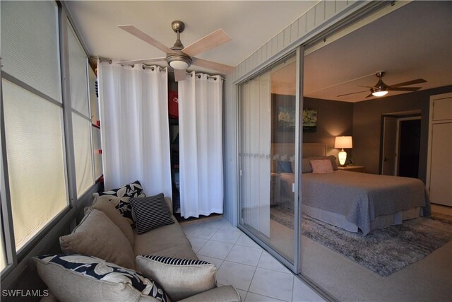 tiled bedroom featuring ceiling fan and a closet