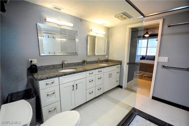 bathroom with ceiling fan, vanity, and toilet