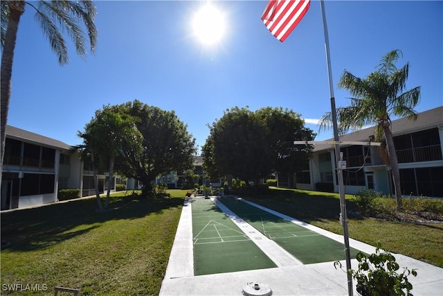 view of property's community with a yard