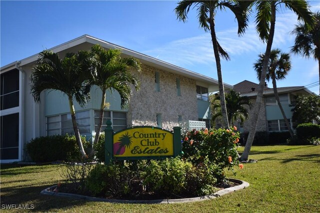 community sign featuring a lawn