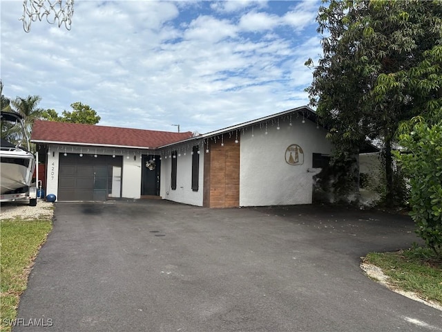 4207 Cindy Ave, Naples, FL 34112 - ranch-style house with a garage, stucco siding, and driveway