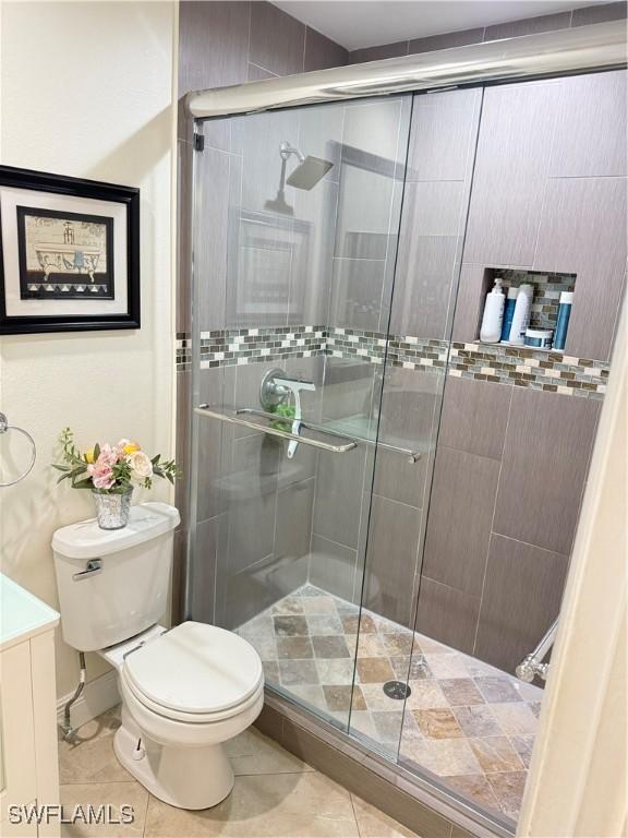 4207 Cindy Ave, Naples, FL 34112 - full bathroom featuring tile patterned flooring, a stall shower, and toilet