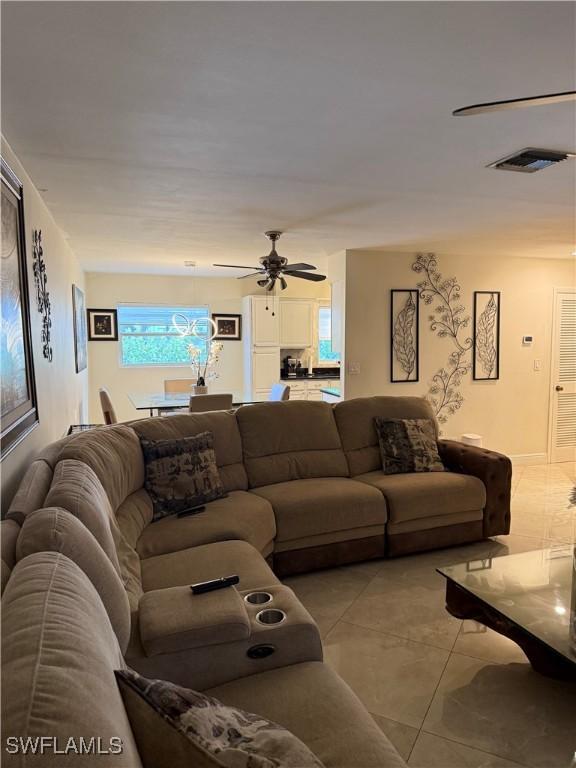 4207 Cindy Ave, Naples, FL 34112 - living room with a ceiling fan, visible vents, and light tile patterned floors