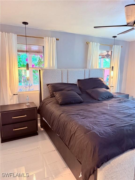 4207 Cindy Ave, Naples, FL 34112 - bedroom with a ceiling fan and multiple windows