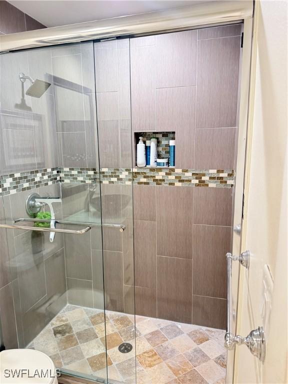 4207 Cindy Ave, Naples, FL 34112 - full bathroom featuring toilet and a shower stall