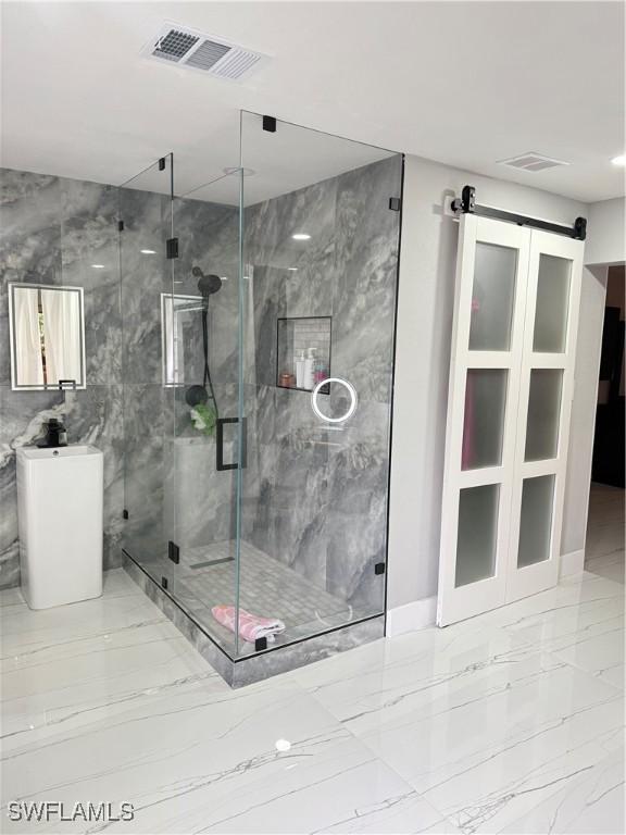 4207 Cindy Ave, Naples, FL 34112 - bathroom featuring visible vents, marble finish floor, and a marble finish shower