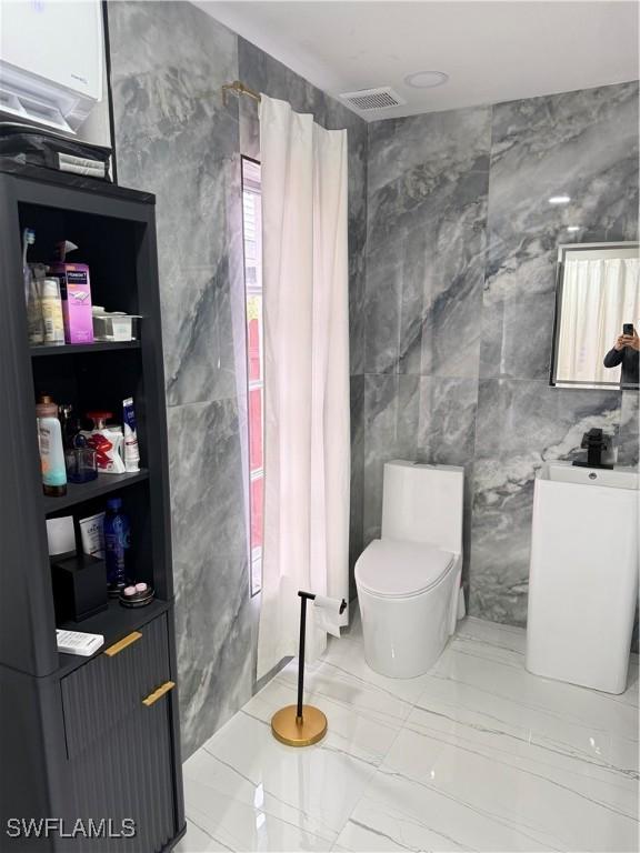 4207 Cindy Ave, Naples, FL 34112 - bathroom featuring tile walls, marble finish floor, toilet, and visible vents