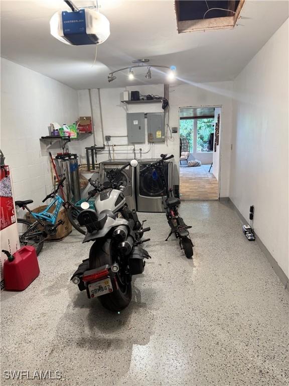 4207 Cindy Ave, Naples, FL 34112 - garage with washing machine and clothes dryer, a garage door opener, and electric panel