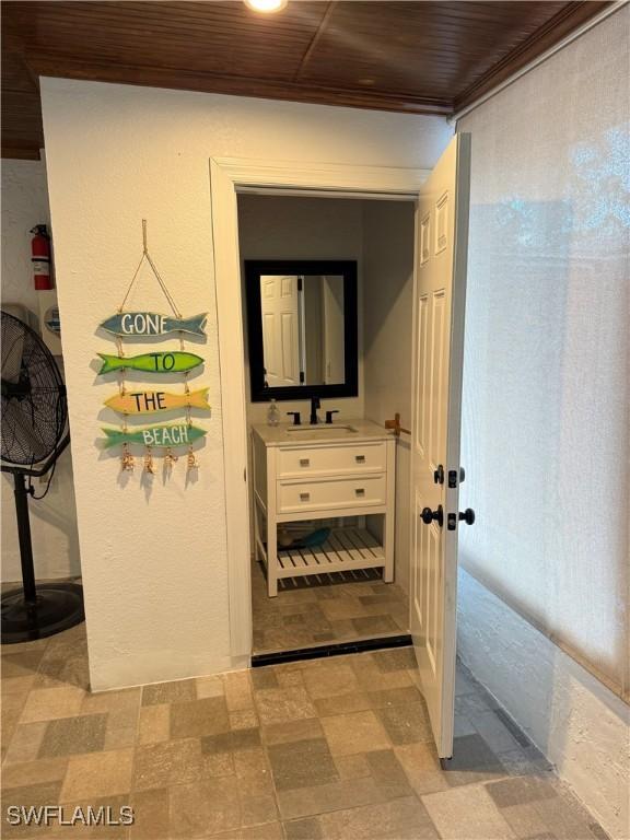 4207 Cindy Ave, Naples, FL 34112 - hallway with a sink, light floors, and wooden ceiling