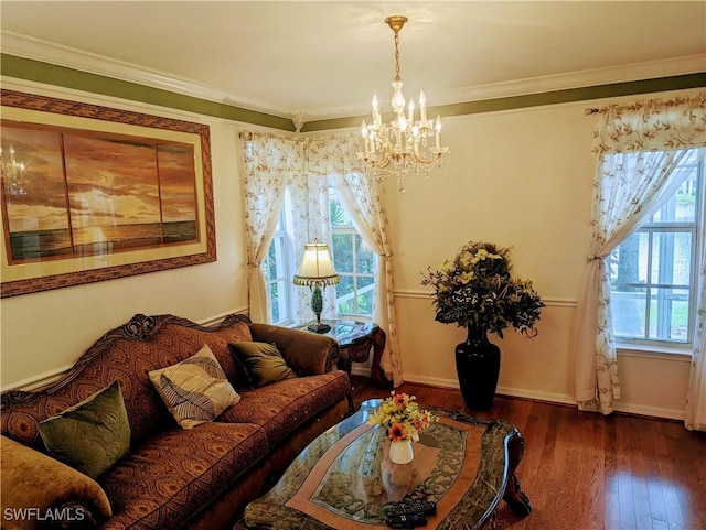 living room with crown molding, a chandelier, and dark hardwood / wood-style floors