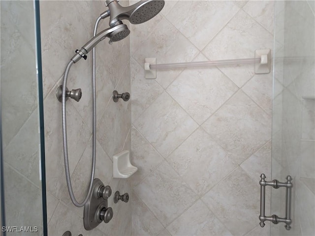 interior details featuring a tile shower