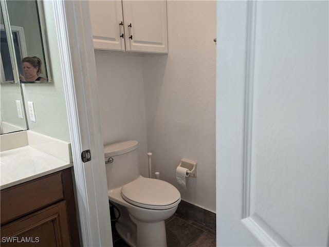 bathroom with tile patterned floors, vanity, and toilet