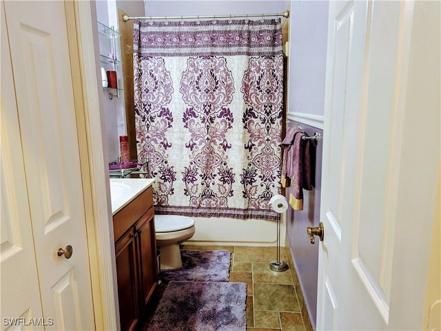 full bathroom featuring shower / bath combo, vanity, and toilet