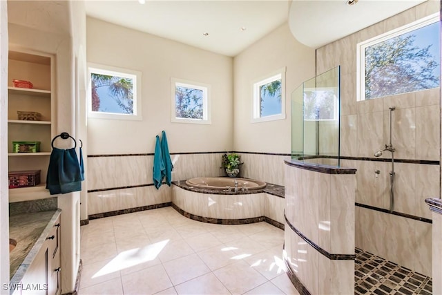 bathroom featuring built in shelves, vanity, shower with separate bathtub, and tile patterned floors