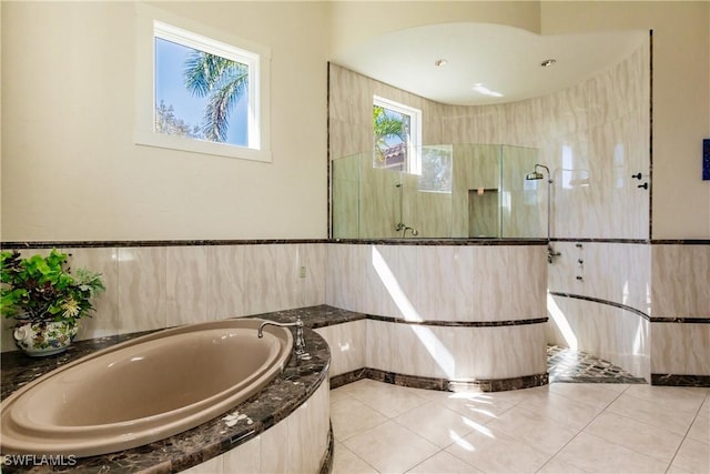 bathroom with tile patterned flooring and independent shower and bath