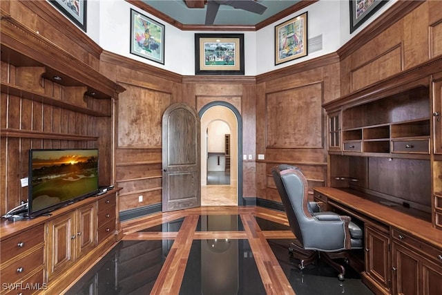 office area featuring wood walls and built in desk