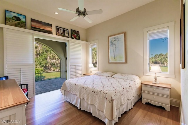 bedroom with access to exterior, light hardwood / wood-style flooring, and ceiling fan