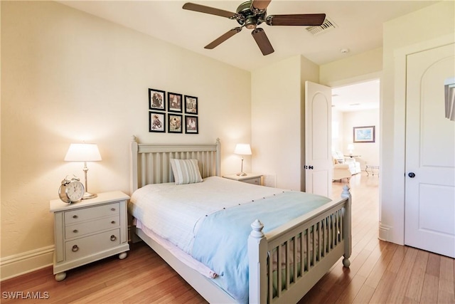 bedroom with ceiling fan and hardwood / wood-style flooring