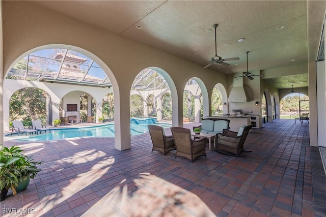 view of patio / terrace with ceiling fan, area for grilling, and exterior bar