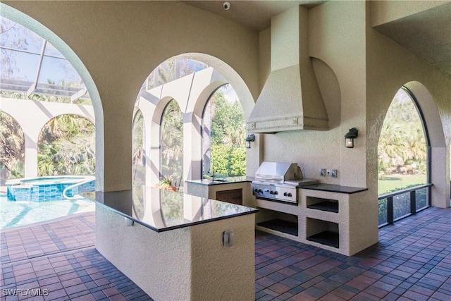 view of patio with an outdoor kitchen, an outdoor bar, and a grill