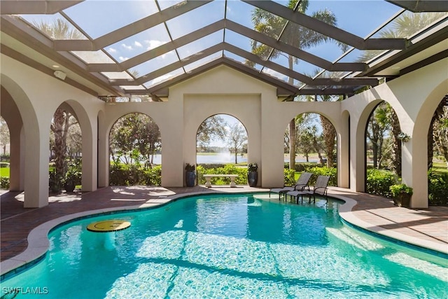 view of swimming pool with a patio and a lanai