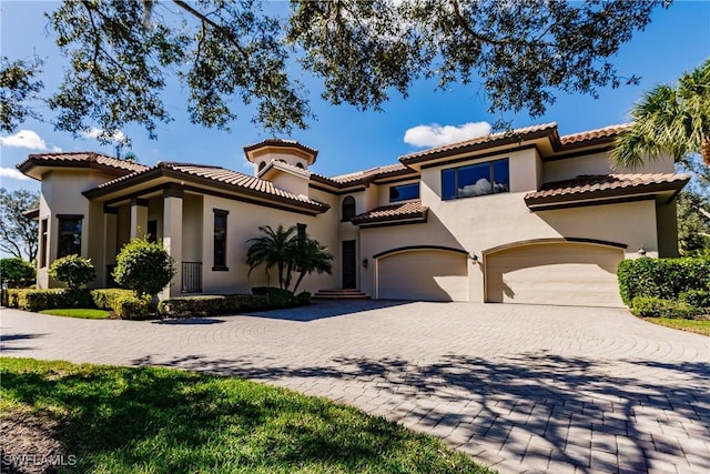 mediterranean / spanish house with a garage