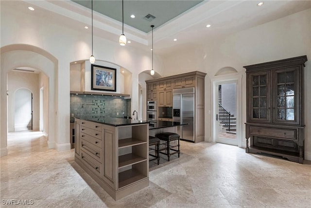 kitchen featuring pendant lighting, a breakfast bar, backsplash, a kitchen island, and stainless steel appliances