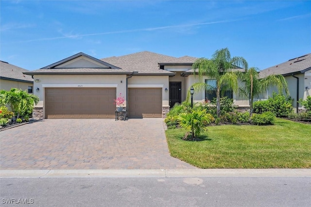 view of front of home with a front lawn and a garage