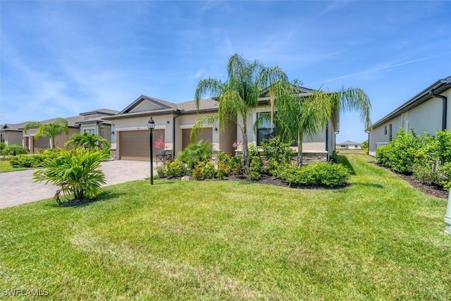 ranch-style home with a front lawn and a garage