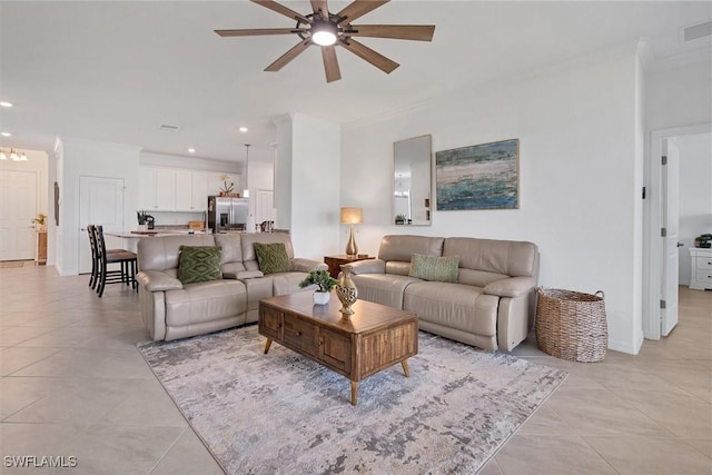 living room with ceiling fan, ornamental molding, and light tile patterned flooring