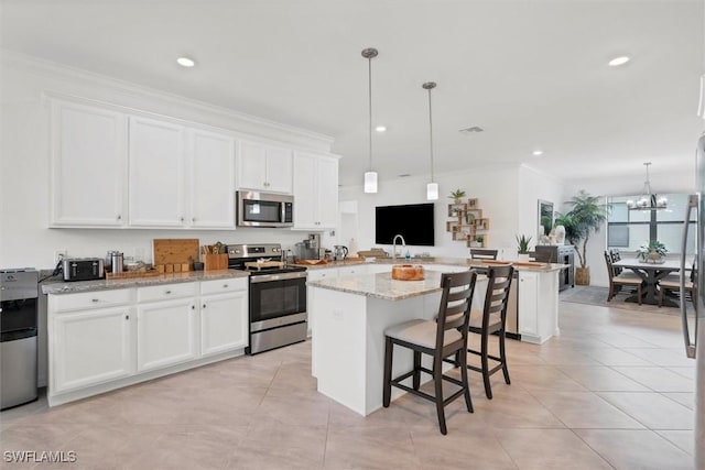 kitchen featuring a center island, white cabinets, and stainless steel appliances