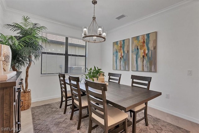 dining area featuring light tile patterned flooring, ornamental molding, and an inviting chandelier