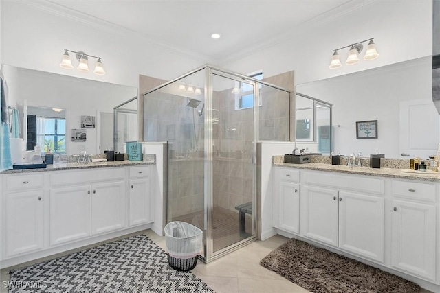 bathroom featuring tile patterned floors, a shower with shower door, and ornamental molding