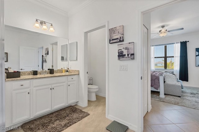 bathroom featuring ceiling fan, tile patterned floors, toilet, vanity, and ornamental molding