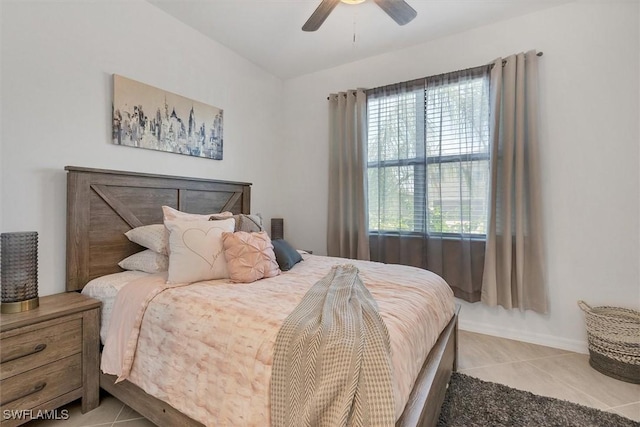 tiled bedroom featuring ceiling fan