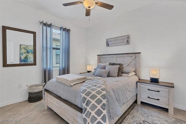 tiled bedroom featuring ceiling fan