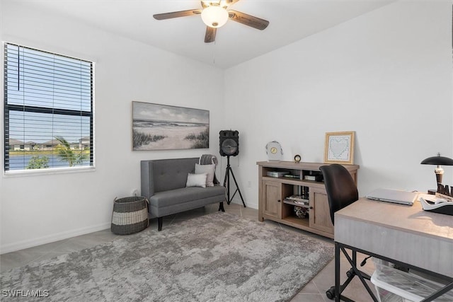 tiled office space featuring ceiling fan