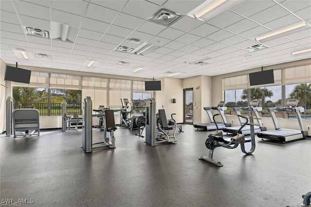 gym featuring a paneled ceiling and plenty of natural light