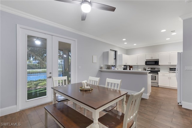 dining area featuring french doors, ornamental molding, ceiling fan, and light hardwood / wood-style flooring