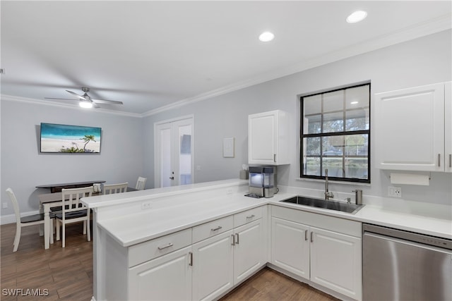 kitchen featuring sink, crown molding, stainless steel dishwasher, kitchen peninsula, and white cabinets