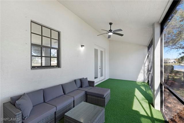 sunroom / solarium with ceiling fan and vaulted ceiling