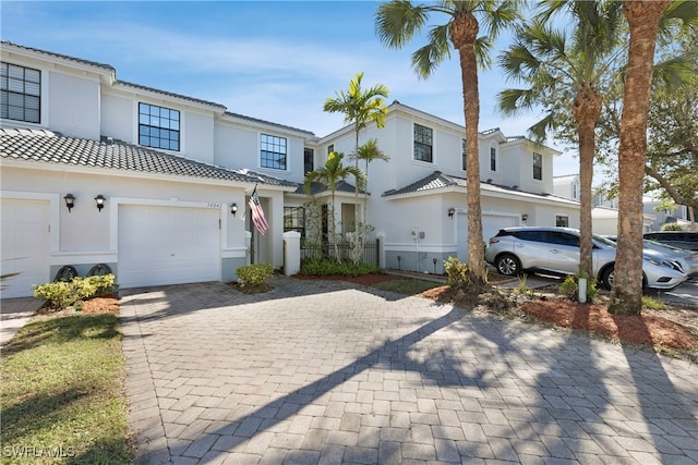 mediterranean / spanish-style home with a garage