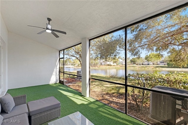 sunroom / solarium featuring a water view